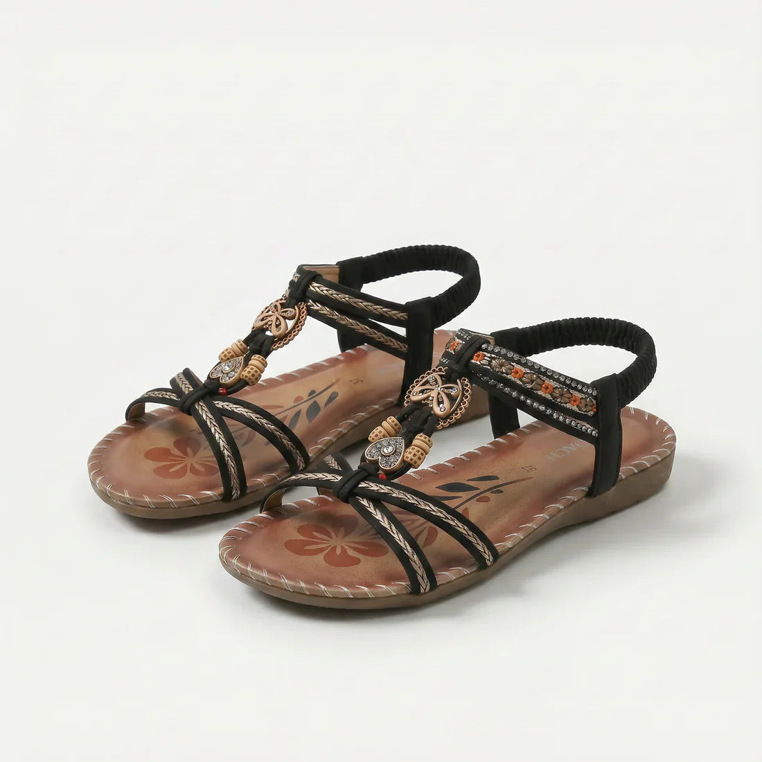 Sandalias ortopédicas negras con tiras marrones y cuentas, pulsera elástica y suela acolchada