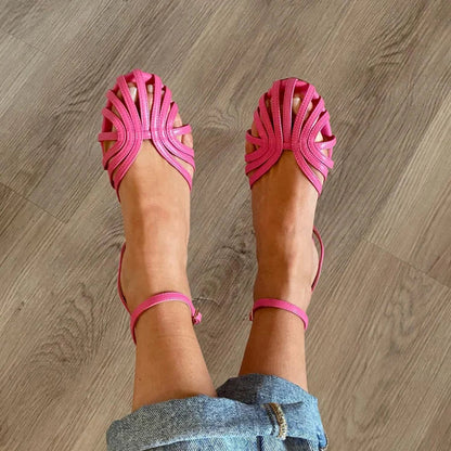 Sandalias fucsia con tiras trenzadas en la parte delantera y pulsera al tobillo.