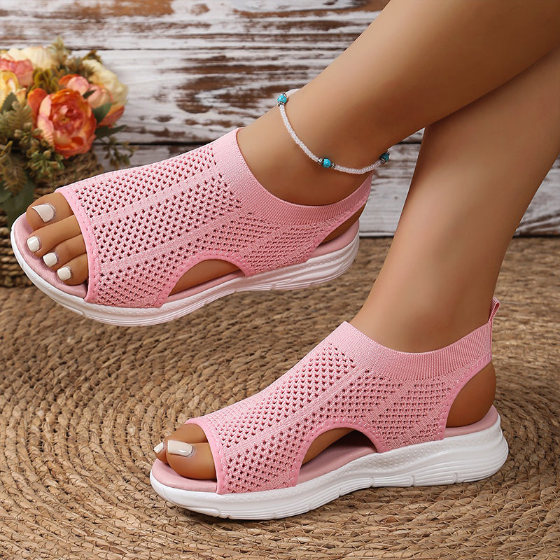 Sandalias ortopédicas rosadas de malla con talón abierto y suela blanca con relieve